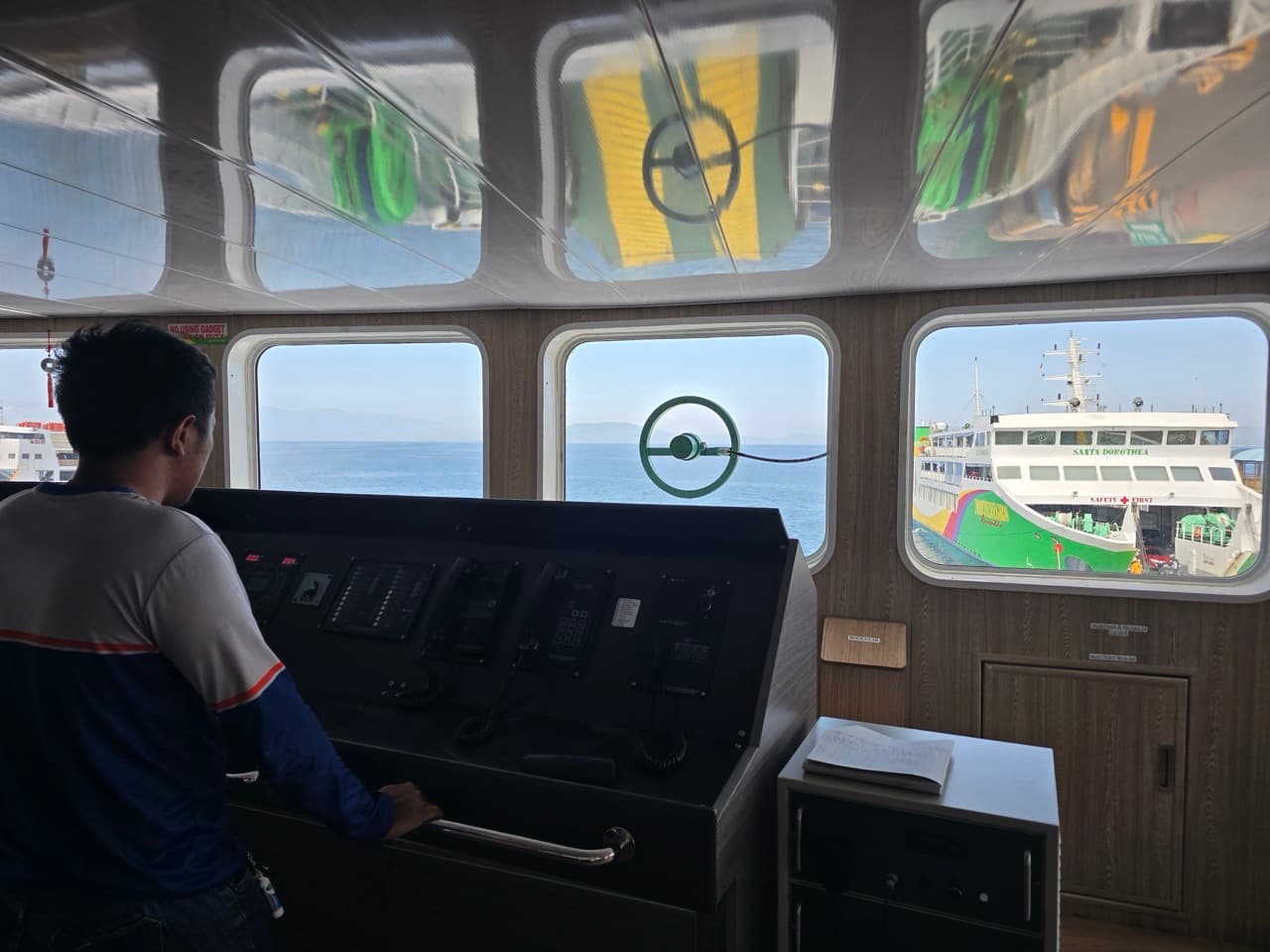 Marine engineer monitoring machinery from the bridge underway