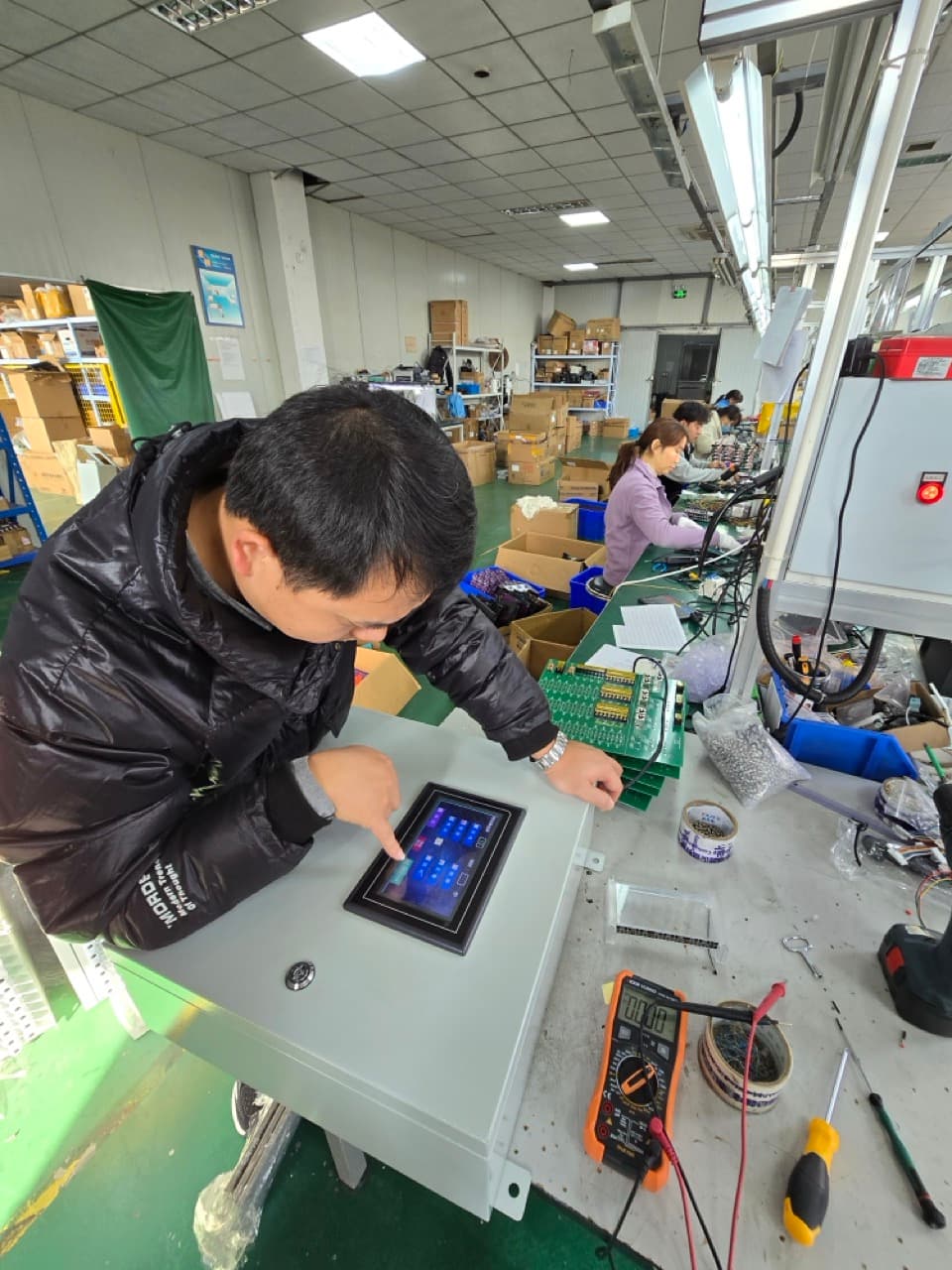 Engineer configuring a touchscreen marine automation control panel